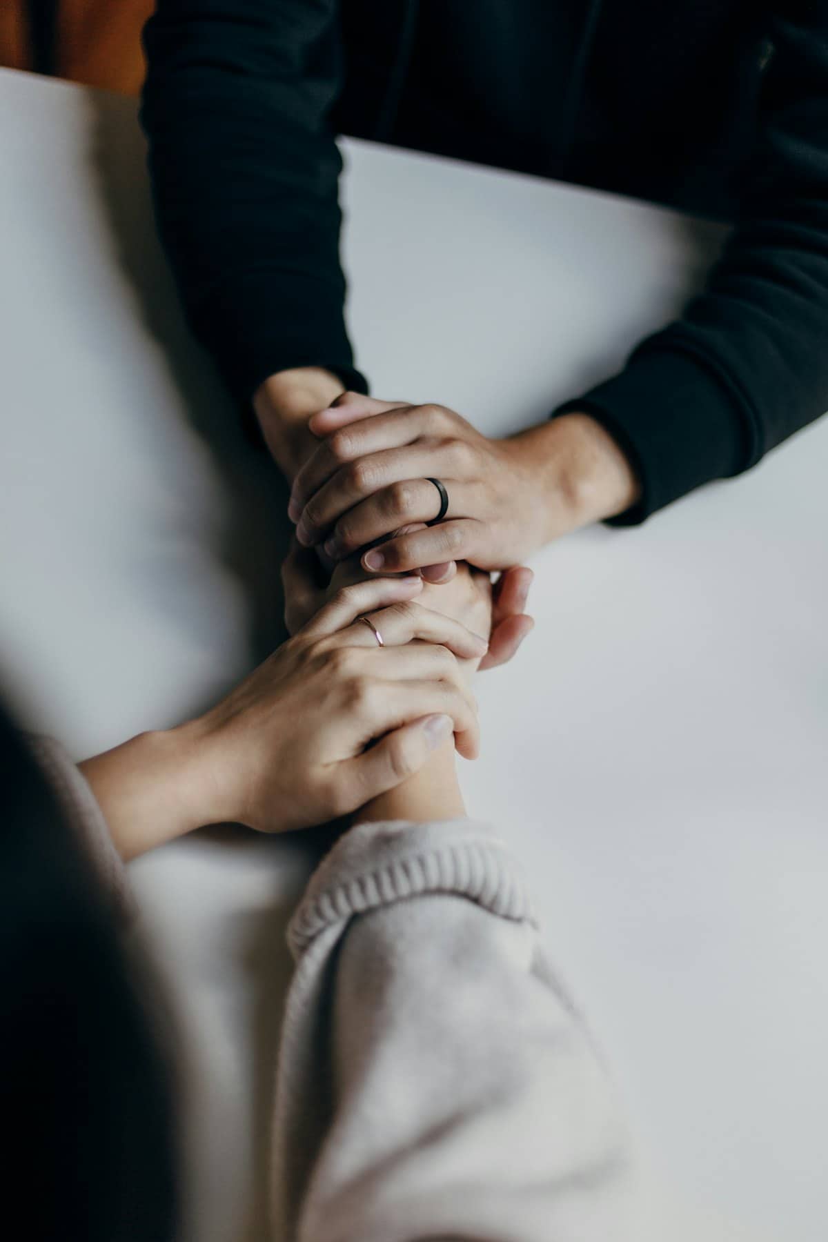Two people holding hands in comfort