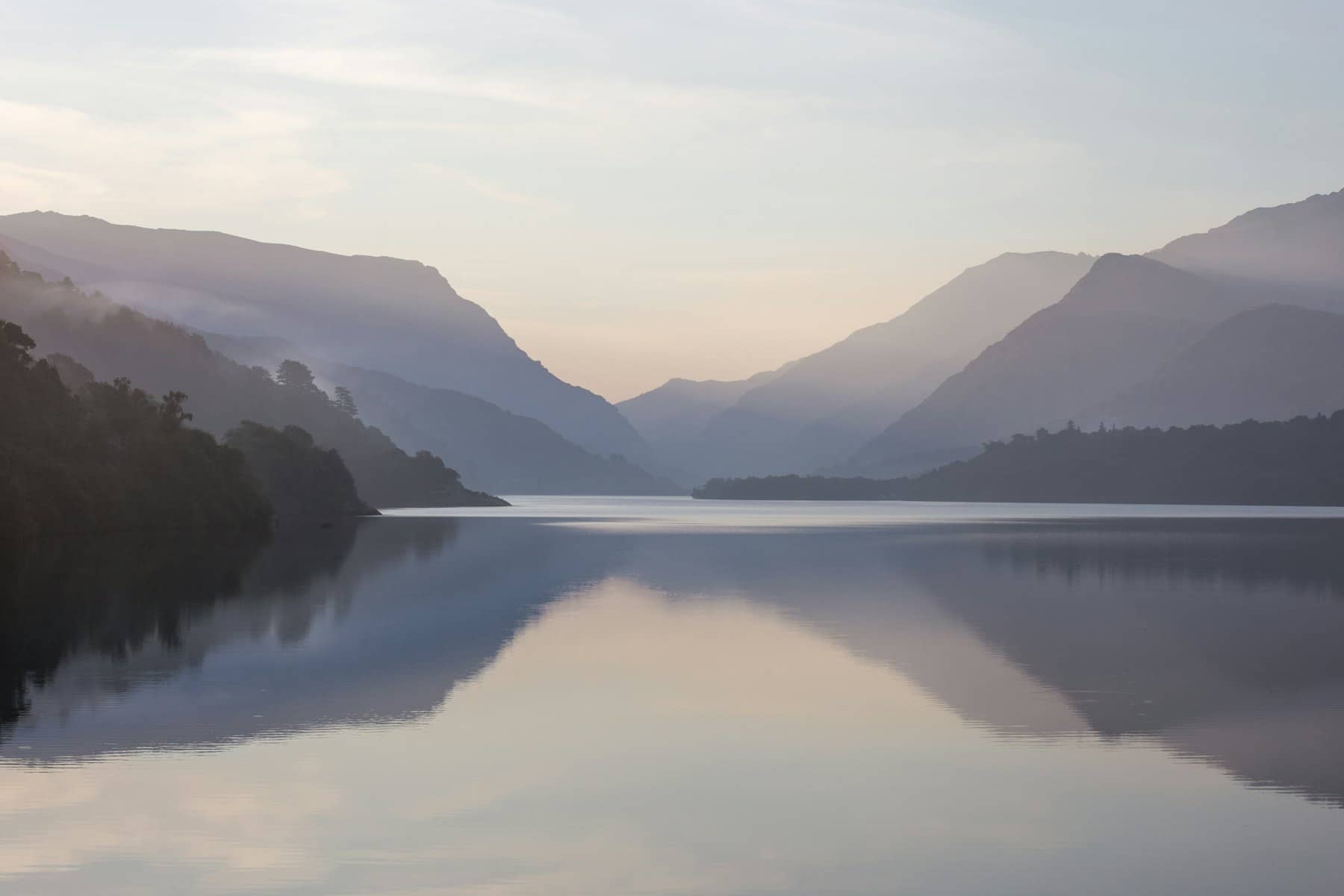 A calm mountain lake at dawn